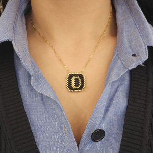 Ατσάλινο Μονόγραμμα ''D'' Με Μαύρες Και Χρυσές ΧάντρεςA23016D